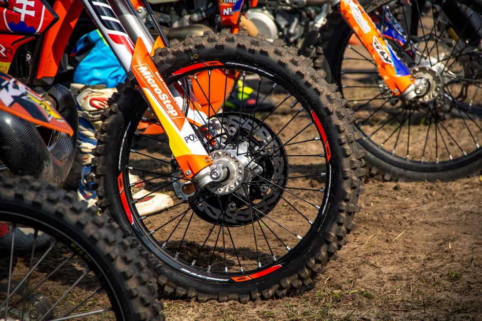 Detailed view of a motocross bike wheel on dirt, captured outdoors in Slovakia.