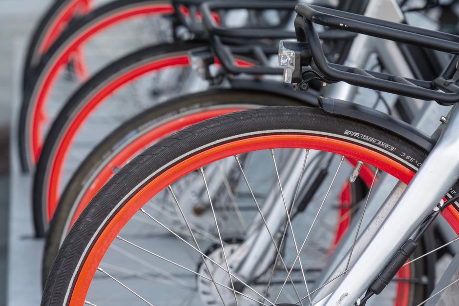 Detailed view of aligned bicycle wheels with vibrant red rims.