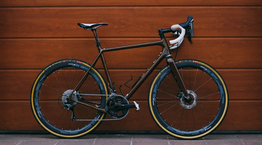 black road bike against wooden wall